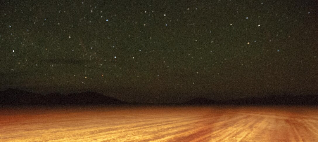 Night shines on a dry lake bed near Nellis Air Force Base, Nev. during Red Flag 16-2 March 10, 2016. C-130 Hercules’ from the 700th Airlift Squadron participated in night time landings on this desert lakebed. (U.S. Air Force photo/Staff Sgt. Daniel Phelps)