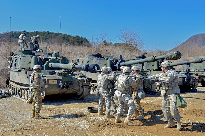 CAMP HOVEY, South Korea (Mar. 10, 2016) - Soldiers from the 1st Battalion, 82nd Field Artillery, 1st Armored Brigade Combat Team, 1st Cavalry Division, "plug the gun," to clean the carbon out of their M109A6 Paladin after firing it at the Rodriguez Live Fire Range.  This week about 200 Soldiers from 1st Battaliion, 82nd FA, added to Dragon history by firing the first rounds in Korea since the unit was last here during the Korean War. 