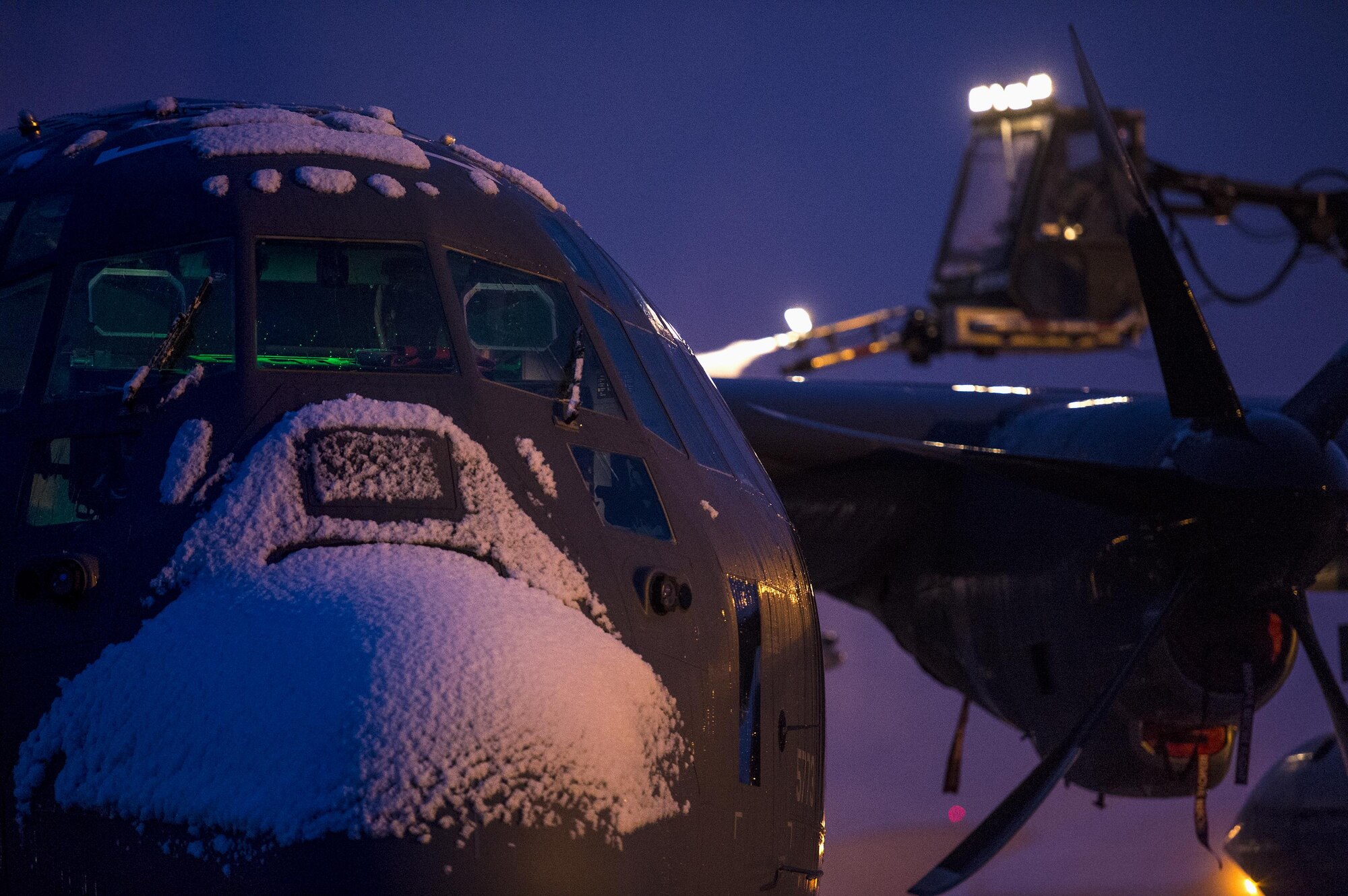 An HC-130J Combat King IIfrom the 71st Rescue Squadron sits on the flightline during de-icing operations, Mar. 4, 2016, at Andrews Air Force Base, Md. Multiple aircraft within Air Combat Command conducted joint aerial training that showcased the aircrafts tactical air and ground maneuvers, as well as its weapon capabilities. (U.S. Air Force photo by Senior Airman Ryan Callaghan/Released)
