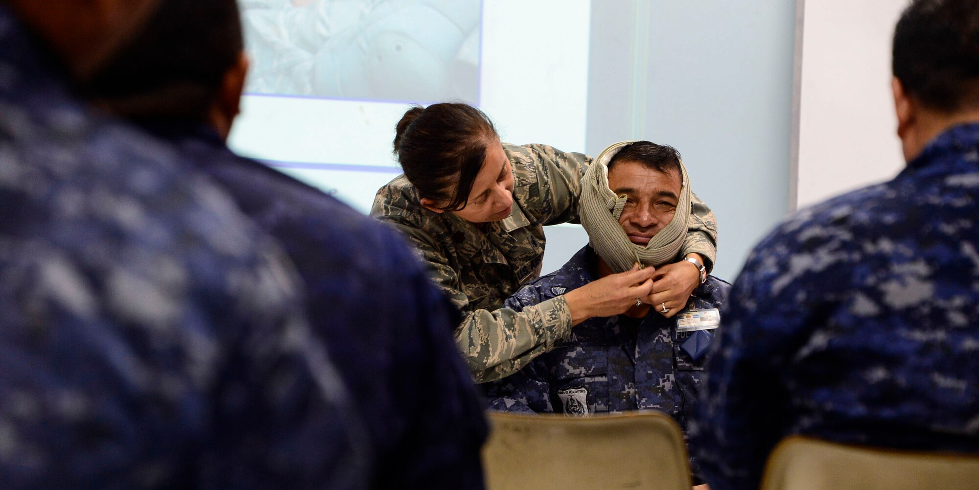 Maj. Helda Carey, 12th Air Force (Air Forces Southern) international health specialist, demonstrates techniques for wrapping a head wound during a U.S. Air Force and Salvadoran air force subject matter expert exchange at Ilopango Air Base, El Salvador, March 8, 2016. 12th Air Force (Air Forces Southern) surgeon general’s office, led a five member team of medics from around the U.S. Air Force on a week-long medical subject matter expert exchange in El Salvador. (U.S. Air Force photo by Tech. Sgt. Heather R. Redman/Released) 