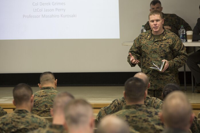 Maj. Daniel White, staff judge advocate at Marine Corps Air Station Iwakuni, Japan, introduces the guest speakers during the Legislation for Peace and Security seminar at MCAS Iwakuni March 11, 2016. Recent changes in national policy gives Japan the capability to take a more proactive stance in matters that may threaten Japan, its citizens and its allies. (U.S. Marine Corps photo by Cpl. Nathan Wicks/Released)