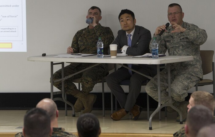 From left to right, U.S. Marine Corps Lt. Col. Jason Perry, military liaison officer with the Japan Ground Self-Defense Force, Masahiro Kurosaki, professor at the Japan National Defense Academy, and U.S. Air Force Col. Derek Grimes, staff judge advocate for United States Forces Japan, answer questions during the Legislation for Peace and Security seminar at Marine Corps Air Station Iwakuni, Japan, March 11, 2016. Recent changes in national policy gives Japan the capability to take a more proactive stance in matters that may threaten Japan, its citizens and its allies. (U.S. Marine Corps photo by Cpl. Nathan Wicks/Released)