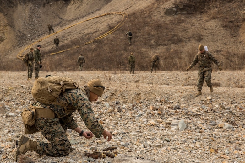 U.S. Marine explosive ordnance technicians with the 13th Marine Expeditionary Unit gather undetonated explosives in order to do a controlled detonation during Exercise Ssang Yong 16 on Suseongri live-fire range, Pohang, South Korea, March 13, 2016. Ssang Yong is a biennial combined amphibious exercise conducted by U.S. forces with the Republic of Korea Navy and Marine Corps, Australian Army and Royal New Zealand Army Forces in order to strengthen interoperability and working relationships across a wide range of military operations.