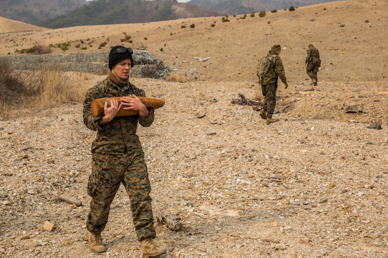 U.S. Marine Sgt. Michael Baker, an explosive ordnance disposal technician with the 13th Marine Expeditionary Unit, carries an undetonated 155 mm round to a consolidation point during Exercise Ssang Yong 16 on Suseongri live-fire range, Pohang, South Korea, March 13, 2016. Ssang Yong is a biennial combined amphibious exercise conducted by U.S. forces with the Republic of Korea Navy and Marine Corps, Australian Army and Royal New Zealand Army Forces in order to strengthen interoperability and working relationships across a wide range of military operations.