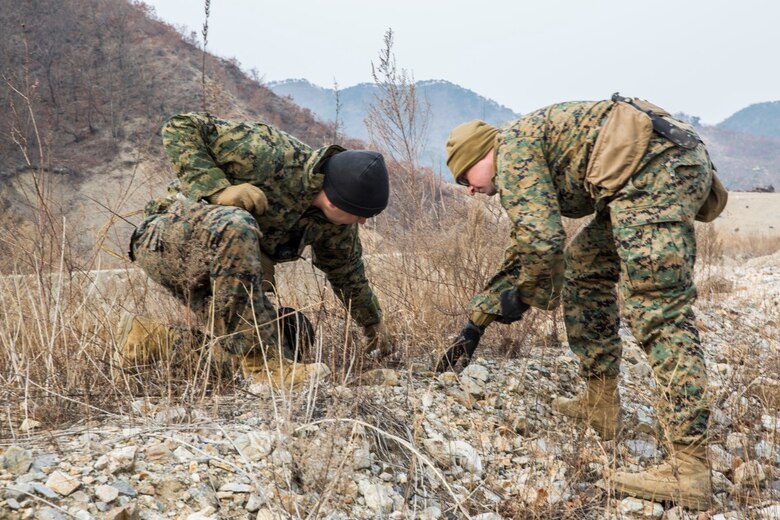 U.S. Marine explosive ordnance disposal technicians Gunnery Sgt. Jordan Torcello and Staff Sgt. Aaron Lane with the 13th Marine Expeditionary Unit investigate pieces of undetonated explosives during Exercise Ssang Yong 16 on Suseongri live-fire range, Pohang, South Korea, March 13, 2016. Ssang Yong is a biennial combined amphibious exercise conducted by U.S. forces with the Republic of Korea Navy and Marine Corps, Australian Army and Royal New Zealand Army Forces in order to strengthen interoperability and working relationships across a wide range of military operations.