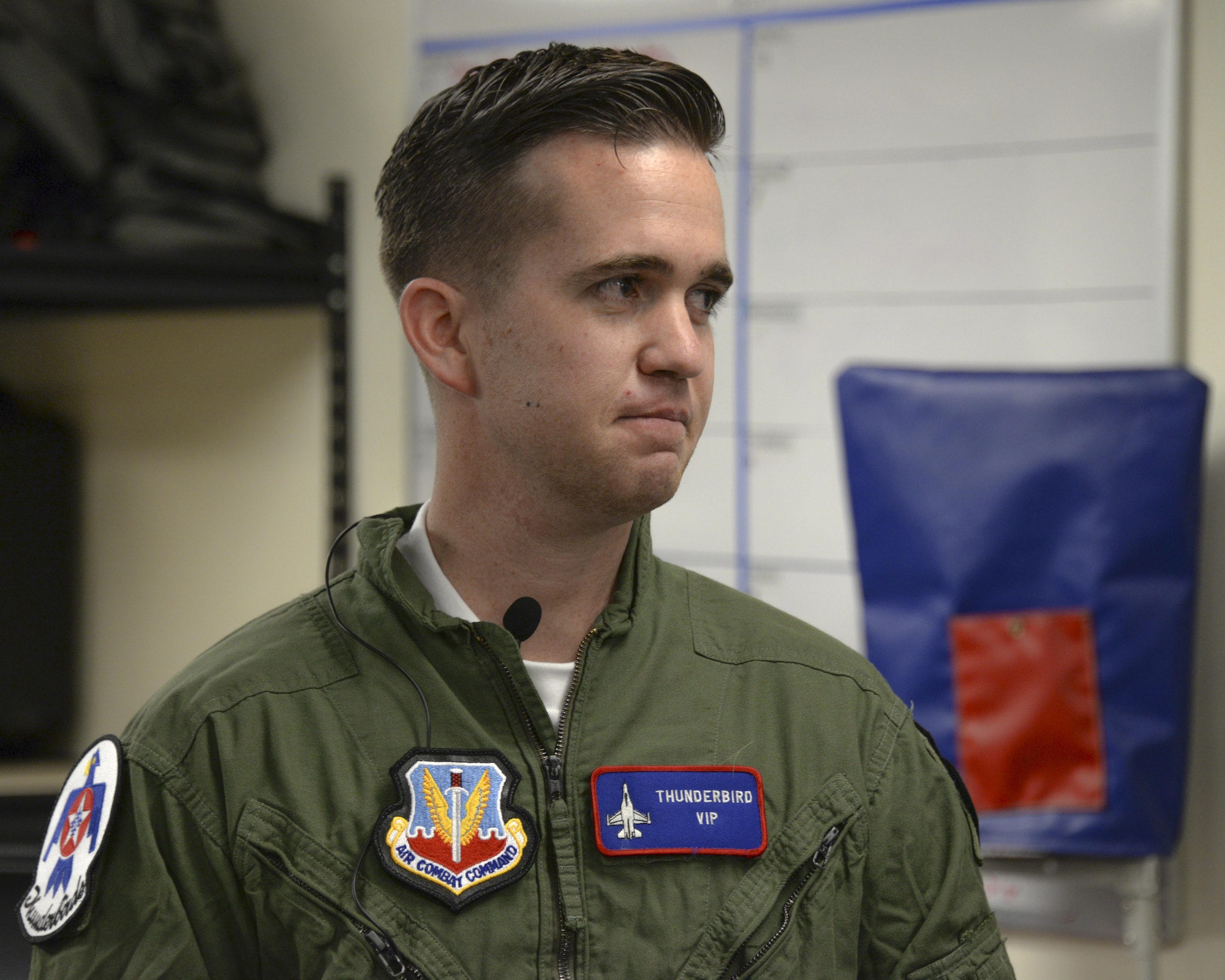 Brendan Lyons, Tucson community hometown hero, listens to a briefing about the aircrew flight equipment he will be using during a flight in a U.S. Air Force Air Demonstration Squadron Thunderbird, an F-16 Fighting Falcon, at Davis-Monthan Air Force Base, Ariz., March 11, 2016. .  Lyons was nominated as a hometown hero because of his commitment to safety and his passion to make Tucson a safer community for cyclists and motorists.  (U.S. Air Force photo by Senior Airman Chris Massey/Released)