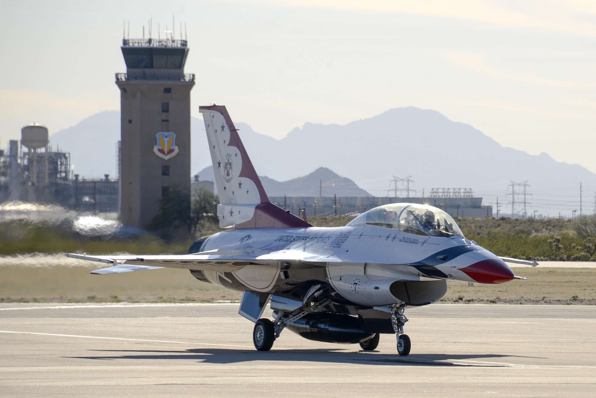 U.S. Air Force Maj. Kevin Walsh, U.S. Air Force Air Demonstration Squadron pilot and operations officer, taxis Thunderbird 7, an F-16 Fighting Falcon, with Brendon Lyons, Tucson community hometown hero, in the rear seat at Davis-Monthan Air Force Base, Ariz., March 11, 2016.  Lyons was nominated as a hometown hero because of his commitment to safety and his passion to make Tucson a safer community for cyclists and motorists.  (U.S. Air Force photo by Senior Airman Chris Massey/Released)