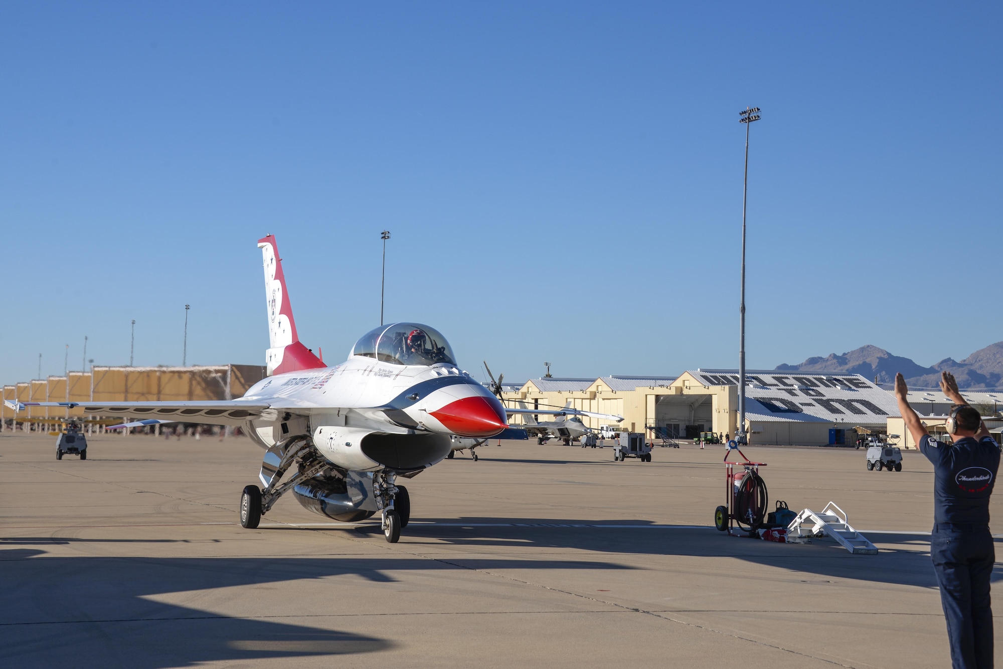 U.S. Air Force Maj. Kevin Walsh, U.S. Air Force Air Demonstration Squadron pilot and operations officer, taxis Thunderbird 7, an F-16 Fighting Falcon, with Brendon Lyons, Tucson community hometown hero, in the rear seat at Davis-Monthan Air Force Base, Ariz., March 11, 2016.  Lyons was nominated as a hometown hero because of his commitment to safety and his passion to make Tucson a safer community for cyclists and motorists.  (U.S. Air Force photo by Senior Airman Chris Massey/Released)
