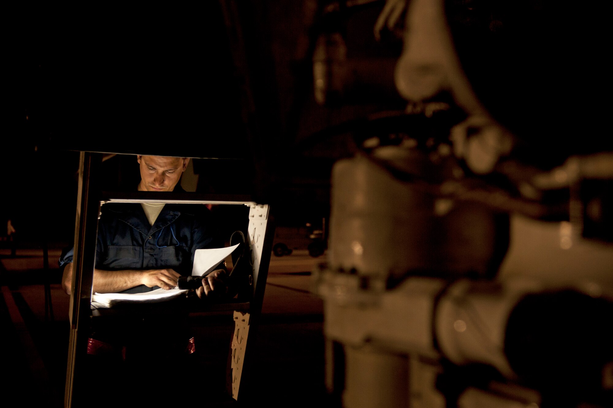 Senior Airman Jeremy Holloway, a dedicated crew chief assigned to the 28th Aircraft Maintenance Squadron, updates maintenance records for a B-1 bomber prior to a Red Flag 16-2 night training sortie at Nellis Air Force Base, Nev., March 10, 2016. Exhaustive efforts are made by ground crew members to ensure the operability of their assigned aircraft and in turn, the safety of the aircrew. (U.S. Air Force photo by Senior Airman Joshua Kleinholz/Released)