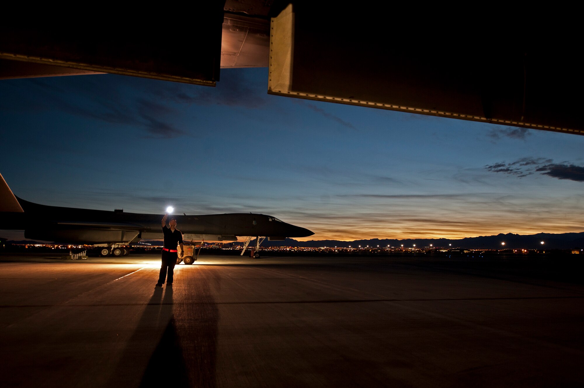 Senior Airman Jeremy Holloway, a dedicated crew chief assigned to the 28th Aircraft Maintenance Squadron, performs aircraft structure checks on a B-1 bomber prior to a Red Flag 16-2 night training sortie at Nellis Air Force Base, Nev., March 10, 2016. The importance of attention to detail is intensified even further in low-light conditions when maintainers work as a team to eliminate risks to aircrew safety. (U.S. Air Force photo by Senior Airman Joshua Kleinholz/Released)