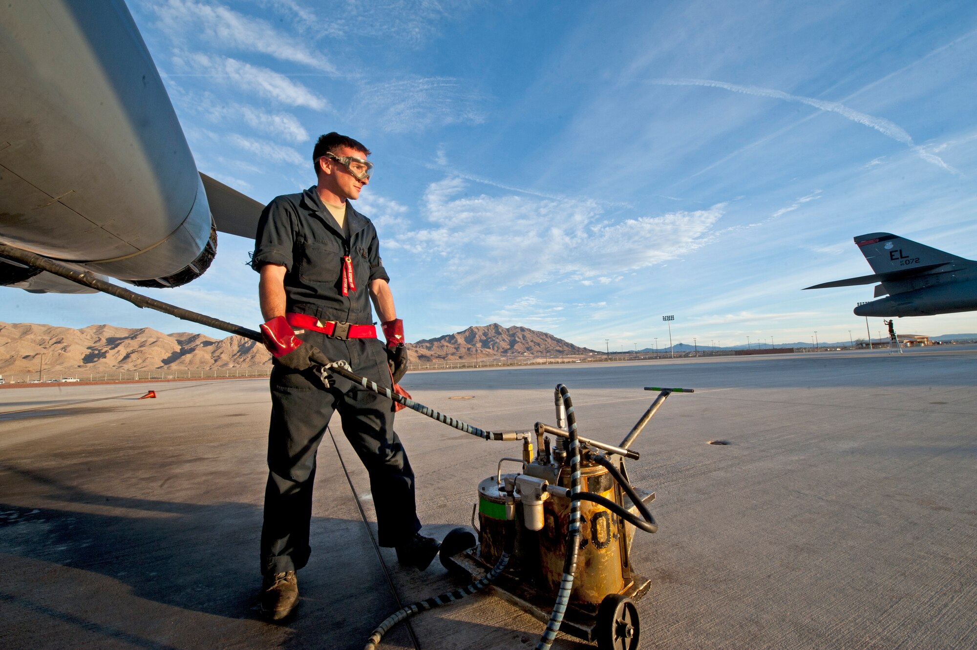 Senior Airman Alex Nolan, a dedicated crew chief with the 28th Aircraft Maintenance Squadron, cycles mechanical fluids in and out of a B-1 bomber prior to a Red Flag 16-2 night training sortie at Nellis Air Force Base, Nev., March 10, 2016. Preparations for safety and operability start hours before flight to ensure aircrews get the most out of their training experience. (U.S. Air Force photo by Senior Airman Joshua Kleinholz/Released)