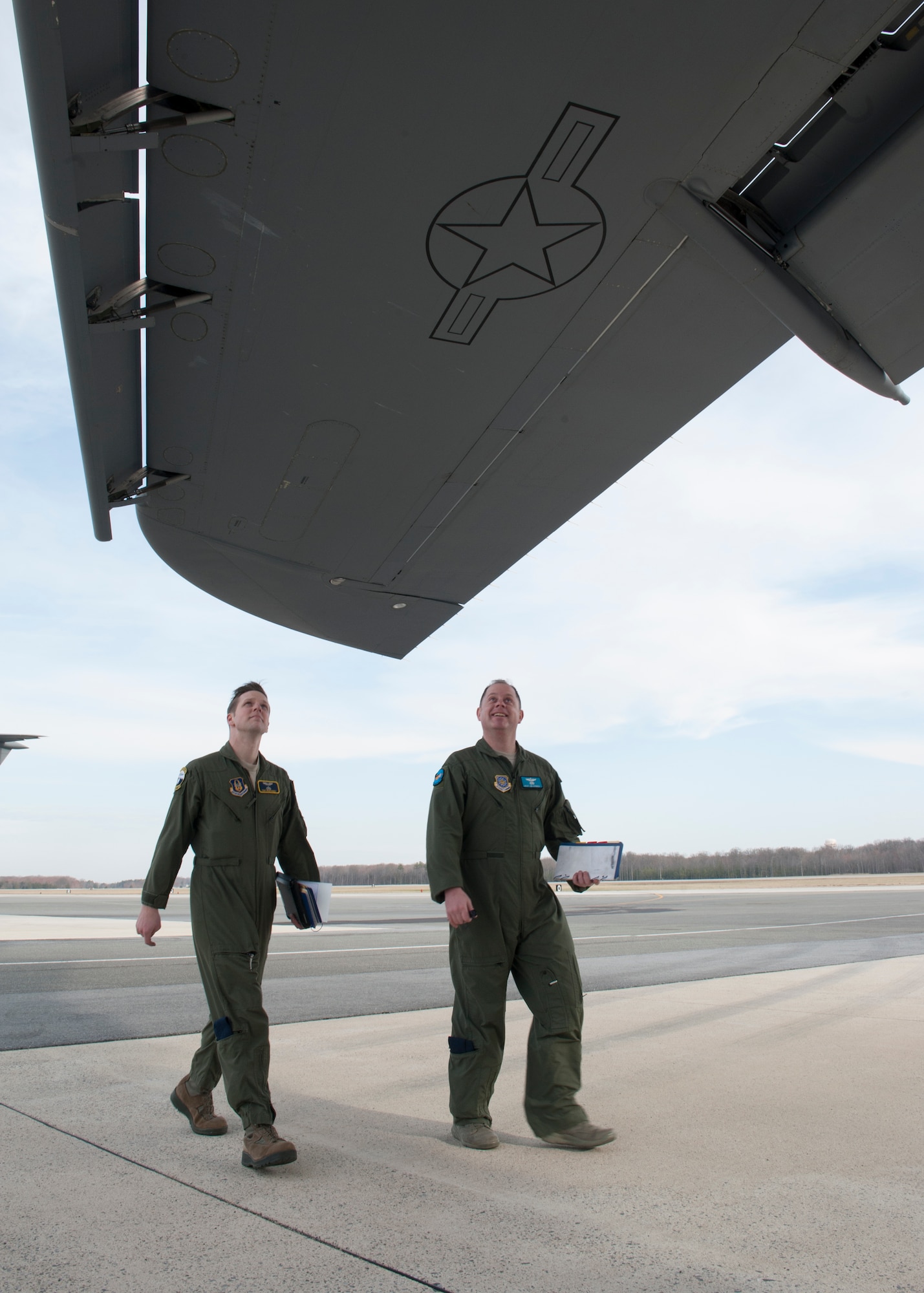 Tech. Sgt. Ryan Berry, 312th Airlift Squadron flight engineer, left, and Master Sgt. James Spinner, 9th AS flight engineer, inspect the underside of a C-5M Super Galaxy’s wing while conducting pre-flight procedures during initial qualification training March 10, 2016, at Dover Air Force Base, Del. Flight engineers perform aircraft visual inspections and in-flight duties, such as operating and monitoring engine and aircraft systems controls, panels, indicators and devices. (U.S. Air Force photo/Senior Airman Zachary Cacicia)