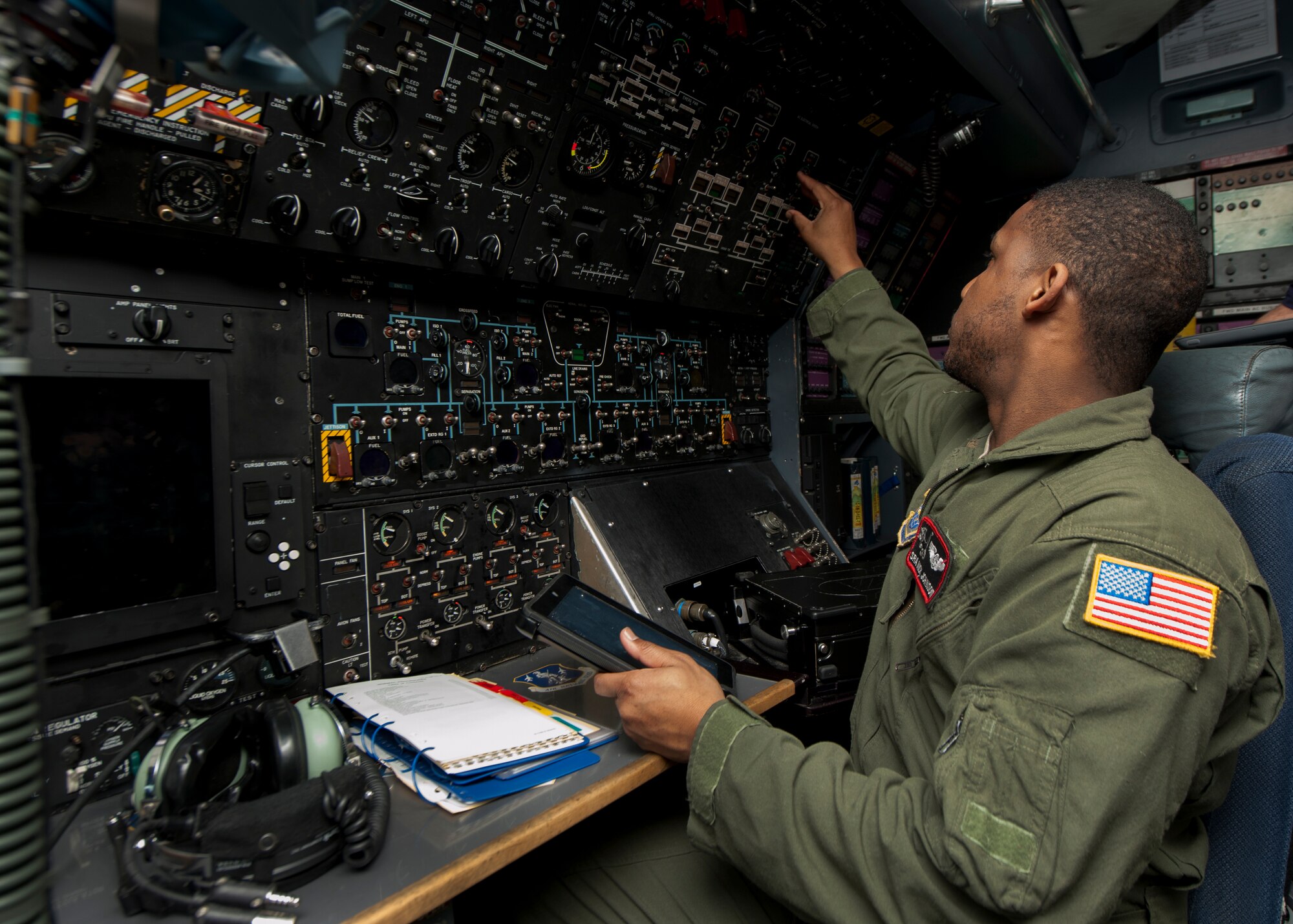 Senior Airman Nick Johnson, 22d Airlift Squadron flight engineer, goes through C-5M Super Galaxy pre-flight procedures during initial qualification training March 10, 2016, inside a C-5M flight deck on Dover Air Force Base, Del. The C-5M is the largest airlifter in the Air Force’s inventory, capable of heavy intercontinental strategic airlift. (U.S. Air Force photo/Senior Airman Zachary Cacicia)