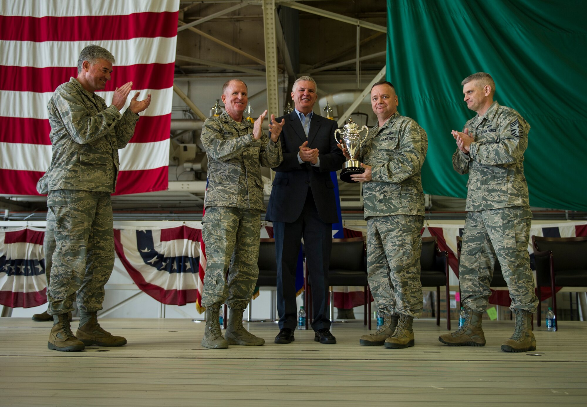 U.S. Air Force Lt. Gen. Stephen W. Wilson (second from left), U.S. Strategic Command (USSTRATCOM) deputy commander, and Mr. W. Gary Gates (center), Strategic Command Consultation (SCC) Committee member, present the 2015 Omaha Trophy, strategic aircraft category, to U.S. Air Force Col. Brian McDaniel (second from right), 92nd Air Refueling Wing commander, and other base leaders during an award ceremony at Fairchild Air Force Base, Wash., March 14, 2016. Also pictured on stage are U.S. Air Force Lt. Gen. Sam Cox (left), 18th Air Force and USSTRATCOM’s Task Force 294 commander, and U.S. Air Force Chief Master Sgt. Christian M. Pugh (right), 92nd Air Refueling Wing command chief master sergeant. Wilson and Gates presented the trophy, on behalf of USSTRATCOM and the SCC, to recognize the 92nd Air Refueling Wing’s contributions to USSTRATCOM’s global strategic missions. The Omaha Trophy, which dates back to the U.S. Air Force’s Strategic Air Command, was originally created by the SCC in 1971. At the time, a single trophy was presented annually as a token of appreciation to USSTRATCOM’s best wing. Since then, the tradition has evolved to unit-level awards that recognize the command’s premier intercontinental ballistic missile (ICBM) wing, ballistic missile submarine, strategic bomber wing and global operations (space/cyberspace) unit. This year, a new category was added to include the combatant command’s top strategic aircraft wing. (U.S. Air Force photo by Airman 1st Class Sean Campbell)