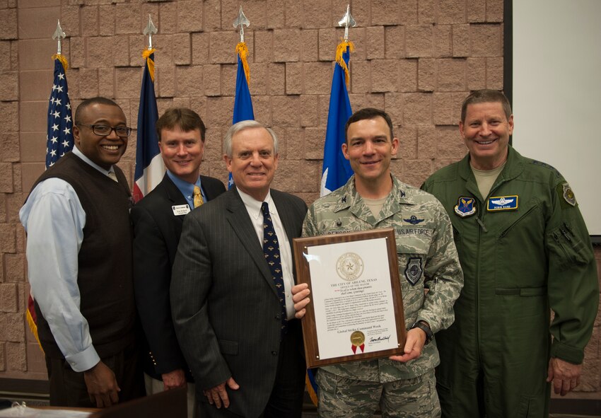 Abilene city councilman Anthony Williams, Abilene Military Affairs Committee chairman Gray Bridwell, and Abilene mayor Norm Archibald present Col. David Benson, 7th Bomb Wing commander, and Gen. Robin Rand, AFGSC commander, with a proclamation declaring March 6-12 “Global Strike Week” March 9, 2016, at the Civic Center in Abilene, Texas. The declaration came as a tribute to Dyess Air Force Base being the chosen location for the Air Force Global Strike Command's Senior Leader Conference. (U.S. Air Force photo by Airman 1st Class Quay Drawdy/Released)