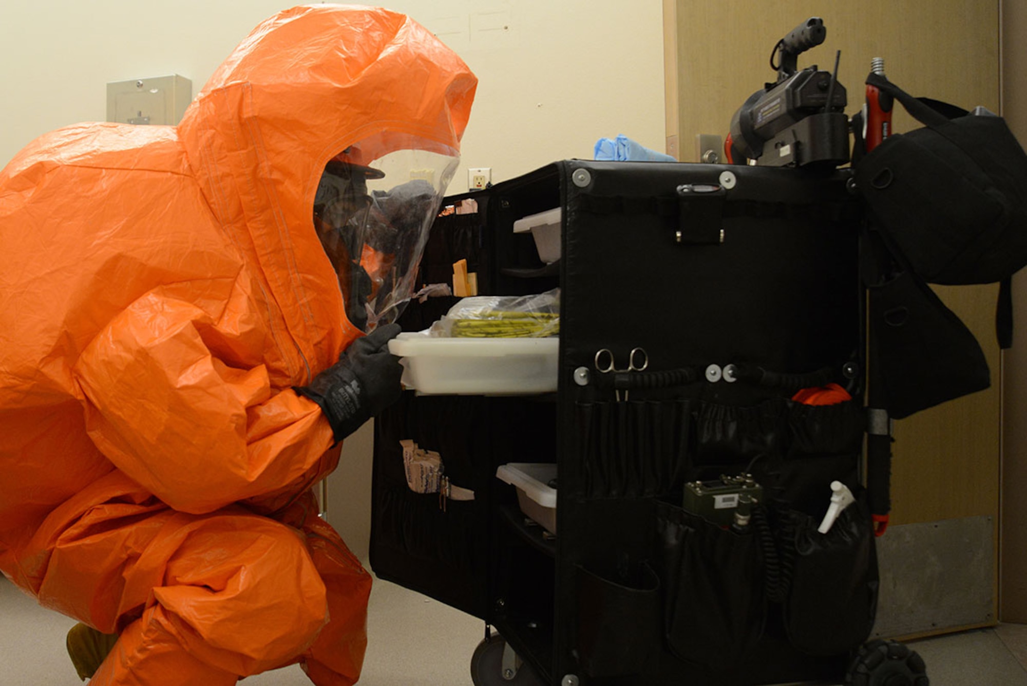 A specialist with the Alaska National Guard’s 103d Civil Support Team looks for contamination bags from an equipment cart during their technical proficiency evaluation test for federal recognition as a regional chemical, biological, radiological and nuclear response unit in Anchorage, Alaska, Feb. 16, 2016. (U.S. Air Force photo by Airman 1st Class Christopher R. Morales)