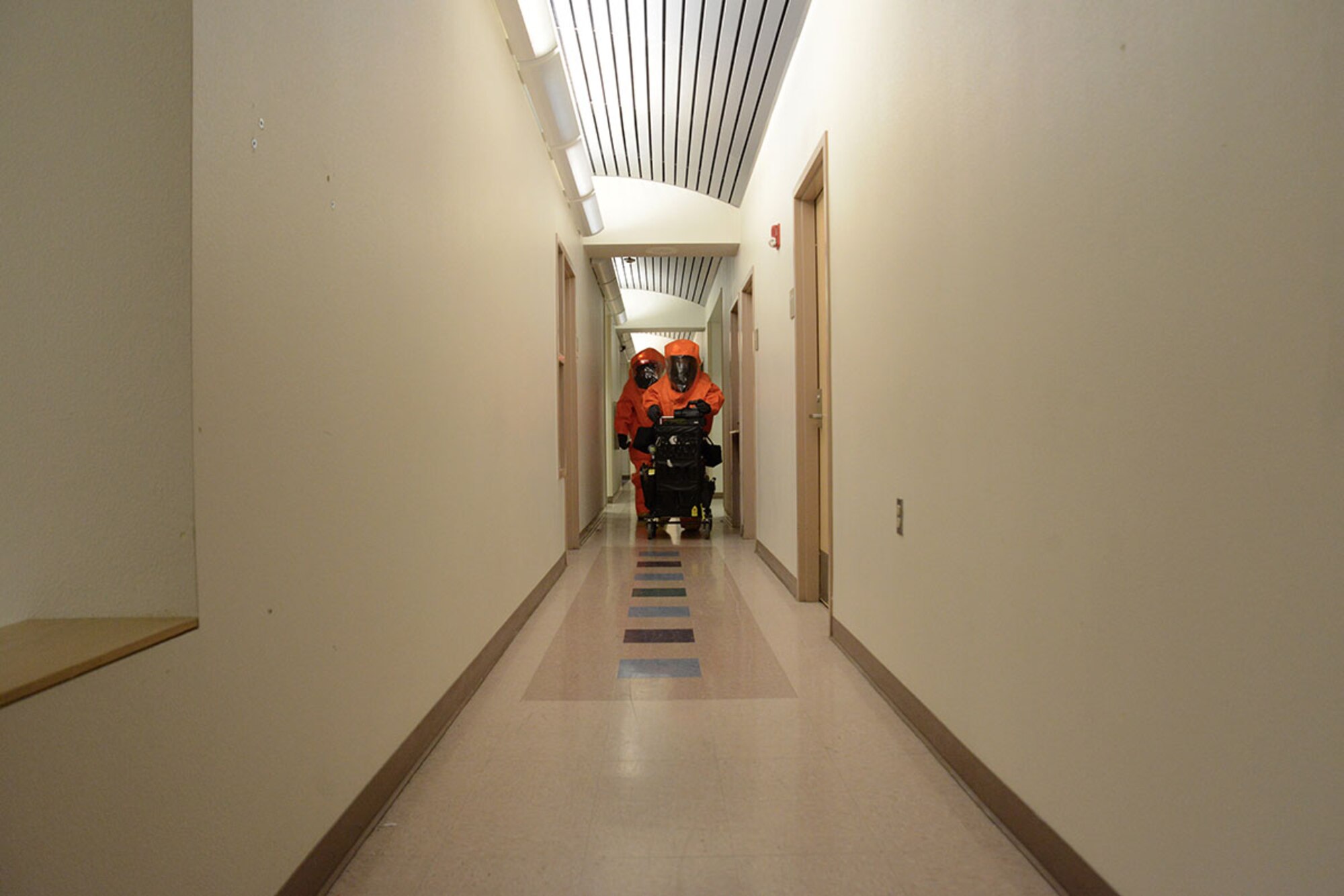 Two members of the Alaska National Guard’s 103d Civil Support Team continue their sweep of the second floor during their technical proficiency evaluation test for federal recognition as a regional chemical, biological, radiological and nuclear response unit in Anchorage, Alaska, Feb. 16, 2016. (U.S. Air Force photo by Airman 1st Class Christopher R. Morales)