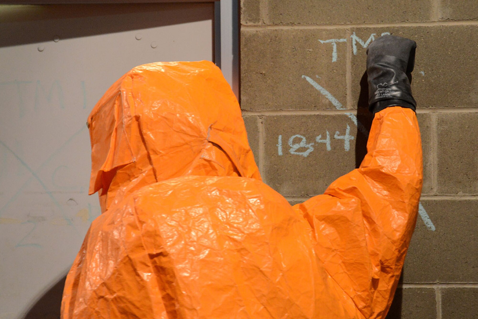 A specialist with the Alaska National Guard’s 103d Civil Support Team marks the entrance of a building during their technical proficiency evaluation test for federal recognition as a regional chemical, biological, radiological and nuclear response unit in Anchorage, Alaska, Feb. 16, 2016. (U.S. Air Force photo by Airman 1st Class Christopher R. Morales)