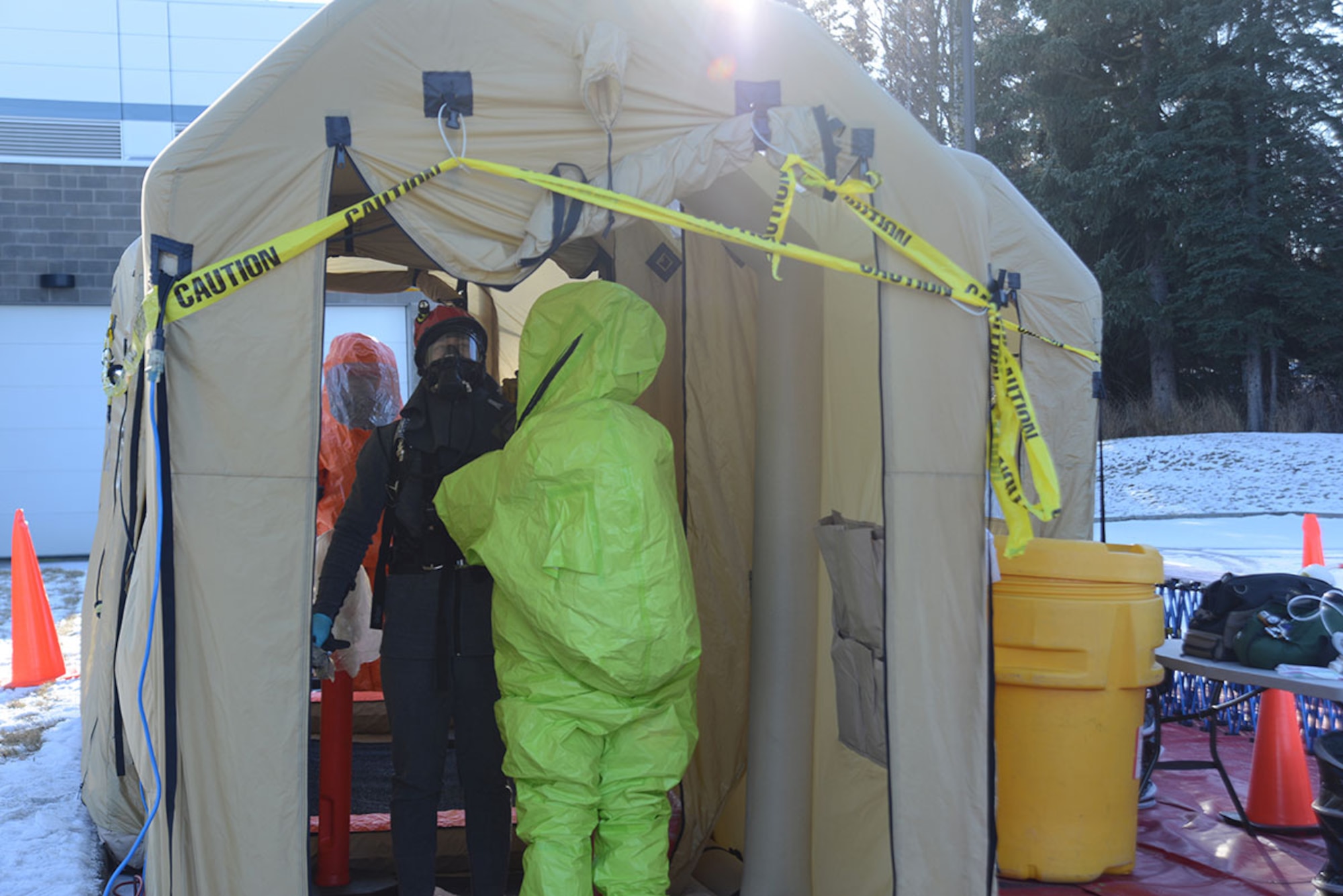 Members of the Alaska National Guard’s 103d Civil Support Team prepare to be decontaminated during their technical proficiency evaluation test for federal recognition as a regional chemical, biological, radiological and nuclear response unit in Anchorage, Alaska, Feb. 16, 2016. (U.S. Air Force photo by Airman 1st Class Christopher R. Morales)