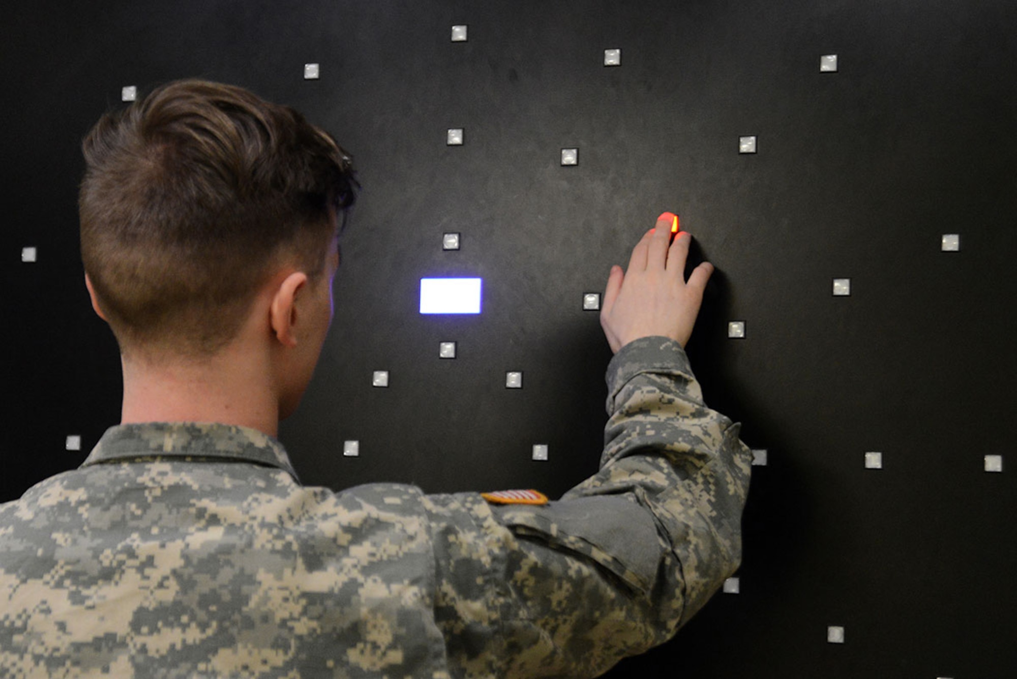 A Soldier takes a cognitive hand-eye coordination test on the Dynavision visuomaster training device at the traumatic brain injury clinic in the Joint Base Elmendorf-Richardson hospital, March 2, 2016. This test evaluates how long it takes the patient to find a red light and the reaction speed to reach it. (U.S. Air Force photo by Airman 1st Class Christopher R. Morales)