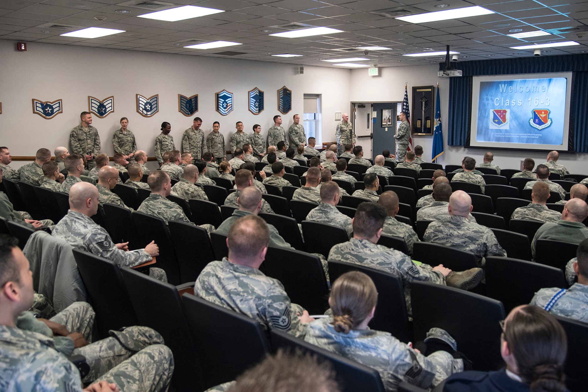 PETERSON AIR FORCE BASE, Colo. – Forrest L. Vosler Noncommissioned Officer Academy instructors line up on the side of the classroom to welcome the first students to attend the new Intermediate Learning Experience course at Peterson Air Force Base, Colo., March 9, 2016. Vosler NCOA is the third NCO Academy in the Air Force to roll-out ILE. The new program is more student-centered rather than instructor-centered allowing students to develop their own solutions to situations. (U.S. Air Force photo by Staff Sgt. Tiffany DeNault)