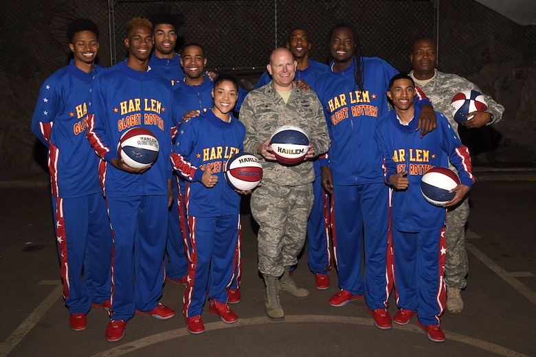 PETERSON AIR FORCE BASE, Colo. – The Harlem Globetrotters present Col. Gary L. Cornn, Jr., 721st Mission Support Group and Cheyenne Mountain Air Force Station installation commander, with an autographed game ball during a visit here March 10, 2016. The Globetrotters, who are celebrating their 90th year, visited and toured “Behind the Blast Doors” as part of the CMAFS ongoing 50th Anniversary celebration. (U.S. Air Force photo by Robb Lingley)