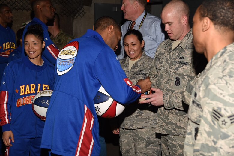 PETERSON AIR FORCE BASE, Colo. - Harlem Globetrotter “Cheese” signs autographs for Cheyenne Mountain Air Force Station Airmen during a visit March 10, 2016. The Globetrotters, who are celebrating their 90th year, visited and toured “Behind the Blast Doors” as part of the CMAFS ongoing 50th Anniversary celebration. (U.S. Air Force photo by Robb Lingley)