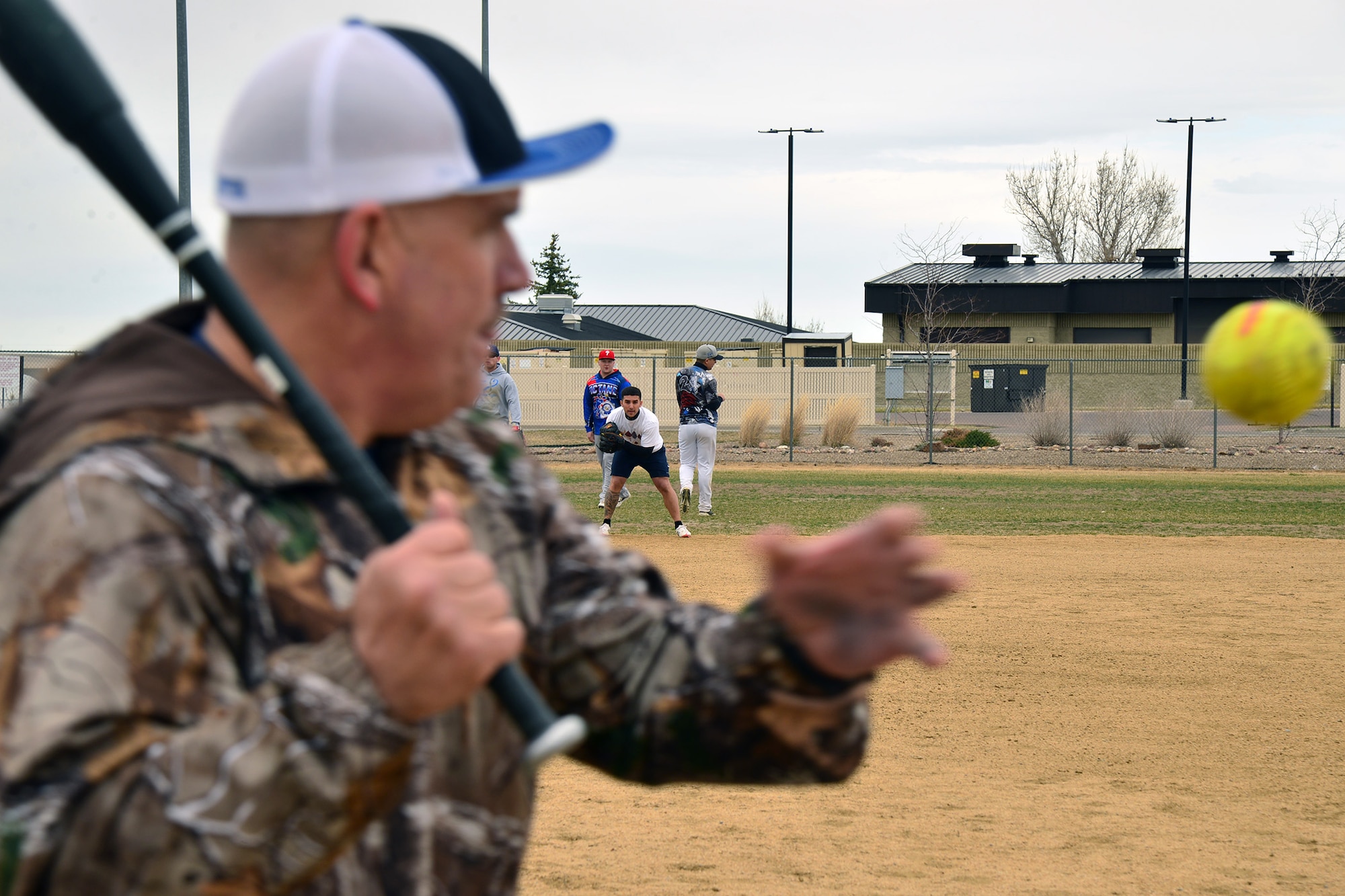 Senior Master Sgt. Eric Butt, 341st Missile Maintenance Squadron first sergeant, hits ground balls to softball tryout participants March 12, 2016, at Malmstrom Air Force Base, Mont. The idea of having a base softball team has been in the works for years and due to the amount of interest for a base softball team, Airmen decided this was the year to start. (U.S. Air Force photo/Airman Daniel Brosam)