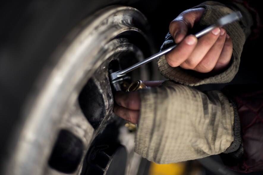U.S. Air Force Senior Airman Bradley Poirier, a crew chief with the 14th Aircraft Maintenance Squadron, tightens a valve on an F-16 Fighting Falcon tire at Misawa Air Base, Japan, March 15, 2016. Poirier regularly checks to make sure tire pressure is correct to help ensure the safety of pilots and air crew. (U.S. Air Force photo by Senior Airman Brittany A. Chase)