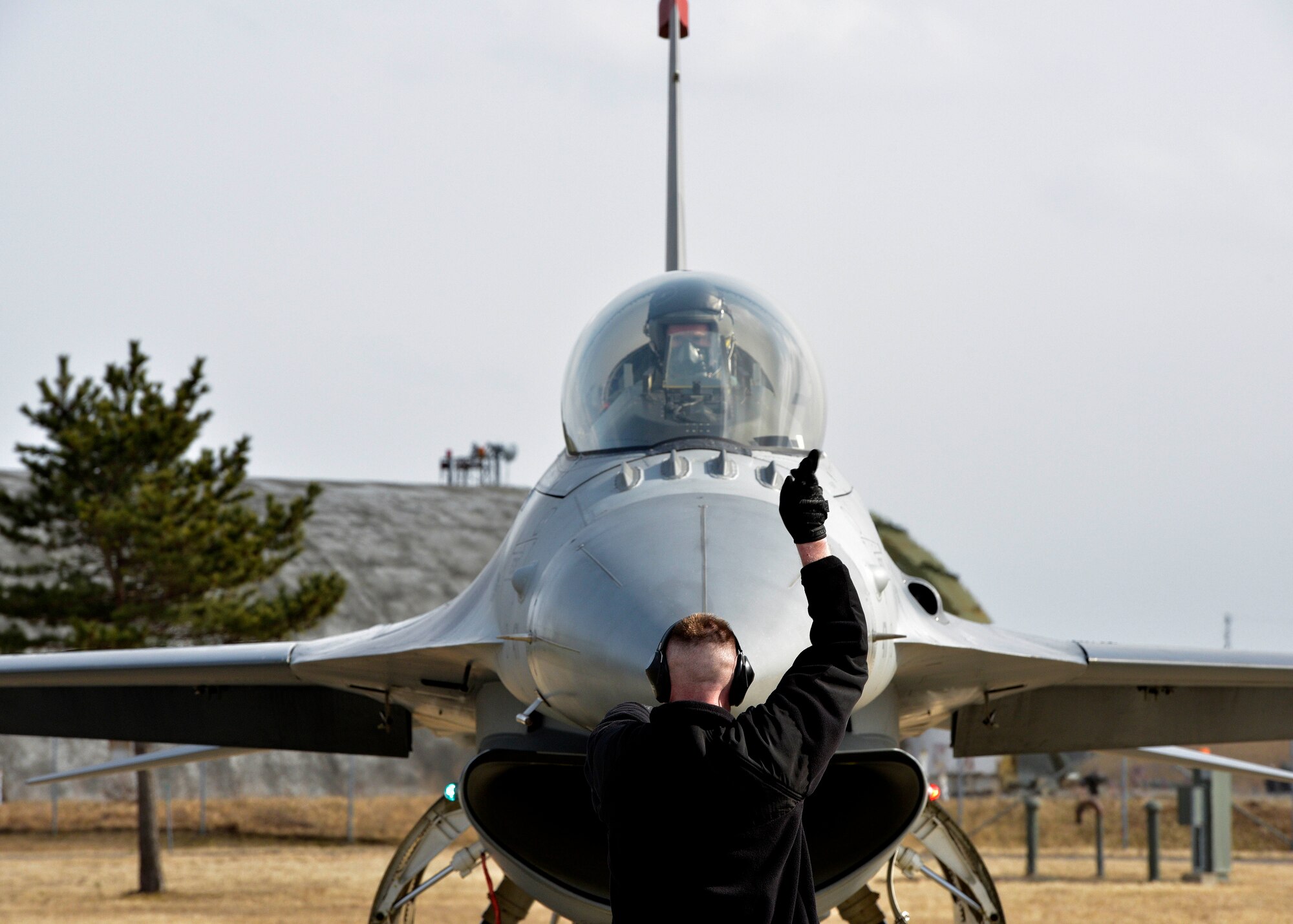 U.S. Air Force Staff Sgt. John Hancock, a crew chief with the Pacific Air Forces’ F-16 Demonstration Team, performs a pre-flight check on an F-16 Fighting Falcon at Misawa Air Base, Japan, March 10, 2016. The F-16 Fighting Falcon can reach speeds up to 1,500 mph and use 27,000 pounds of thrust. The demonstration team pilots are accompanied by a team of eight maintainers covering every aircraft specialty who travel away from home station for airshows. (U.S. Air Force photo by Senior Airman Deana Heitzman)