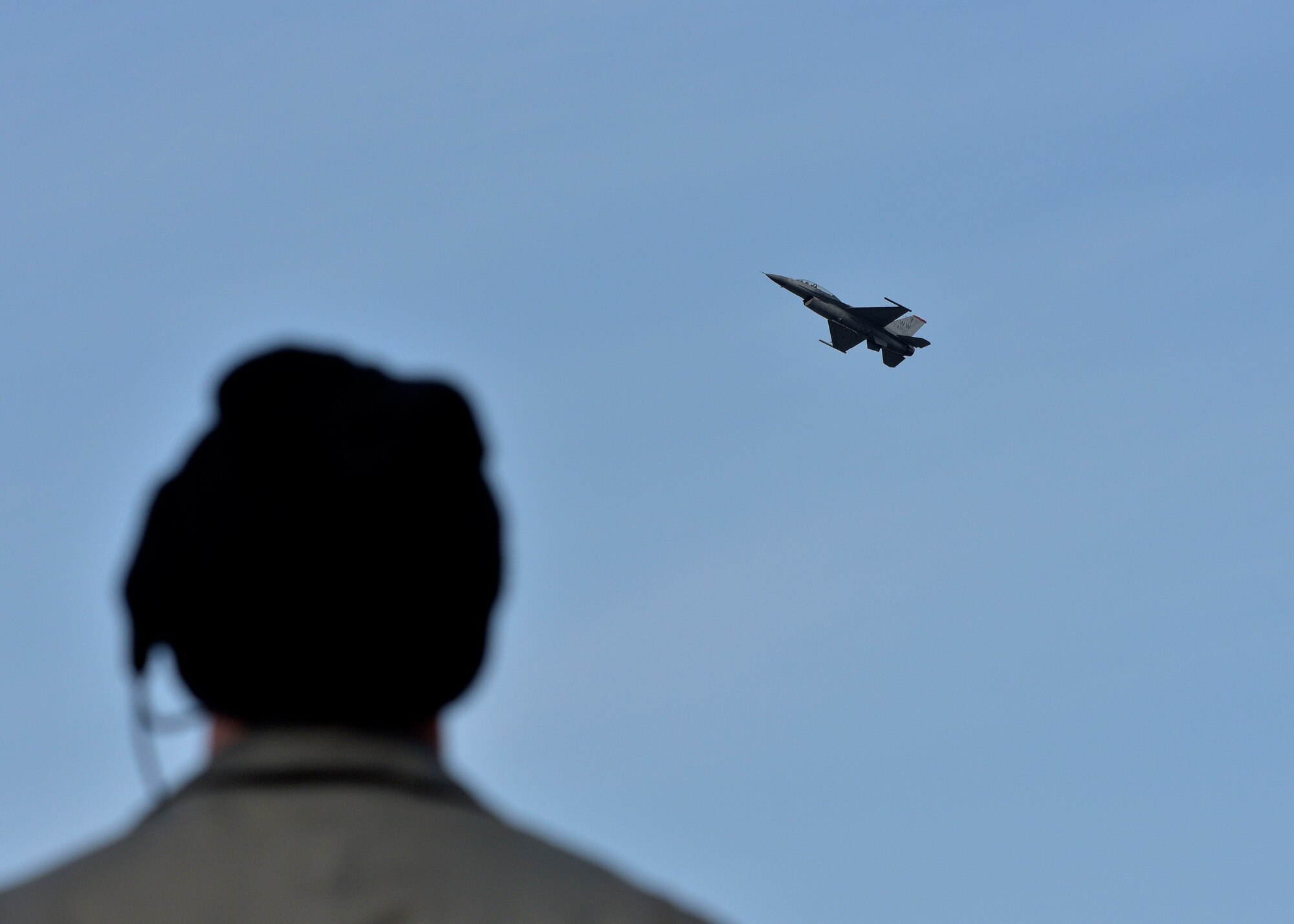 U.S. Air Force Maj. Austin Brown, the outgoing pilot with the Pacific Air Forces’ F-16 Demonstration Team, performs the role of safety observer during the second solo demonstration flight of Capt. Richard Smeeding, an incoming pilot with the Pacific Air Forces Demonstration Team, at Misawa Air Base, Japan, March 10, 2016. The demonstration team is comprised of two pilots, who serve as the demonstration pilot and the safety observer. (U.S. Air Force photo by Senior Airman Deana Heitzman)