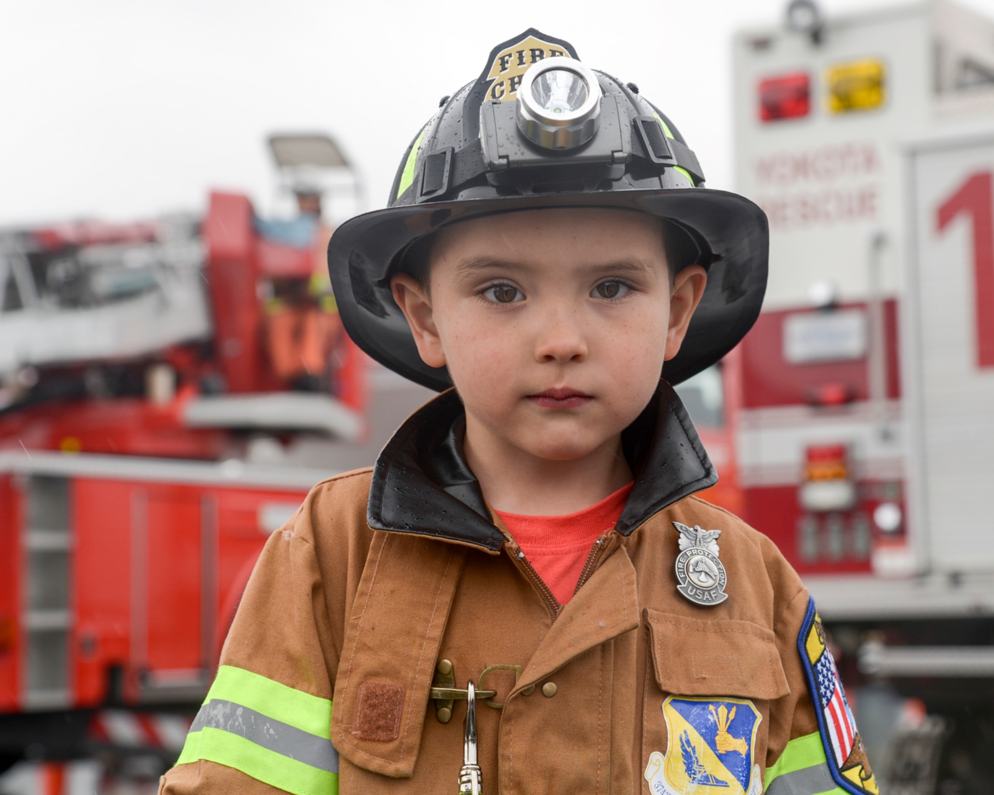 Ethan Nernberger, 5, son of Tech. Sgt. Nathaniel Nernberger, 374th Maintenance Group quality assurance inspector, poses for a photo in front of fire trucks during the safety festival at Yokota Air Base, Japan, March 11, 2016. Ethan has dream of becoming a firefighter. (U.S. Air Force photo by Machiko Imai/Released) 