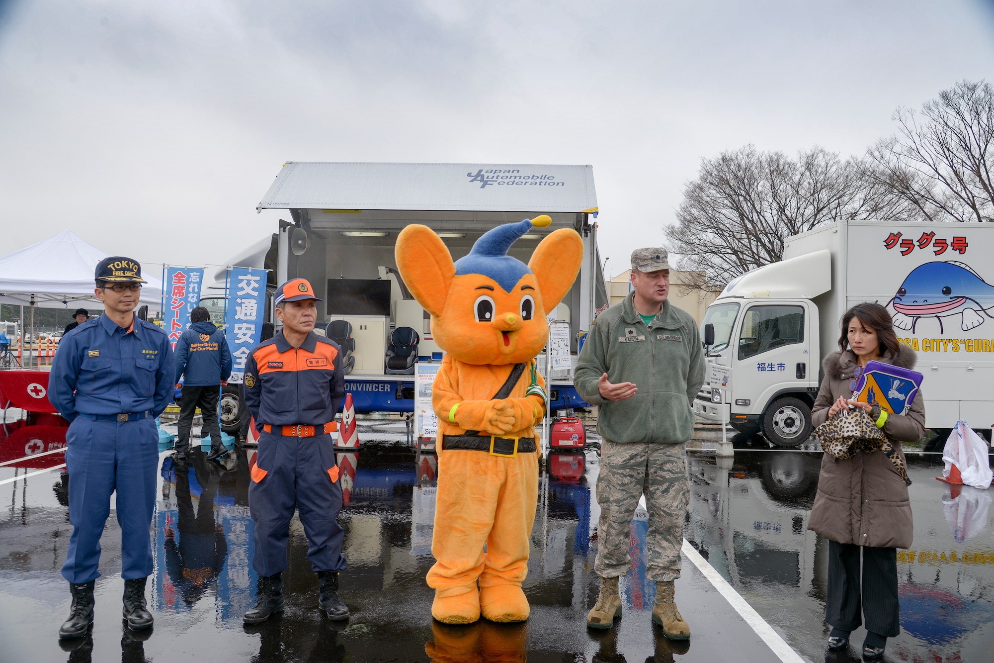 Lt. Col. Erick Gaulin, 374th Airlift Wing chief of safety, briefs local media during the safety festival at Yokota Air Base, Japan, March 11, 2016. The 374th Airlift Wing safety office provided Yokota residents with various events such as the Metropolitan Police Department motorcycle unit demonstration, traffic safety demonstration, earthquake and smoke house information, firefighting and fire ladder trucks experience, seatbelt simulator and child car seat checks. (U.S. Air Force photo by Machiko Imai/Released) 
