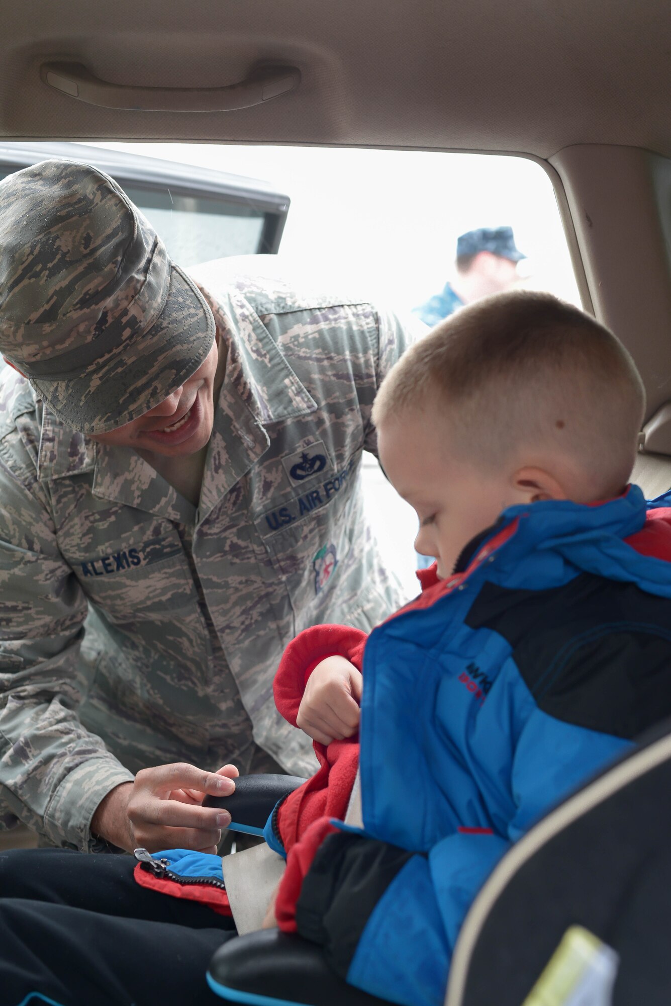 Staff Sgt. Trevor Alexis, 374th Civil Engineer Squadron lead fire crew chief, inspects a child seat during the safety week at Yokota Air Base, Japan, March 10, 2016. The safety week was designed to improve personal and wingman’s safety. (U.S. Air Force photo by Machiko Imai/Released)