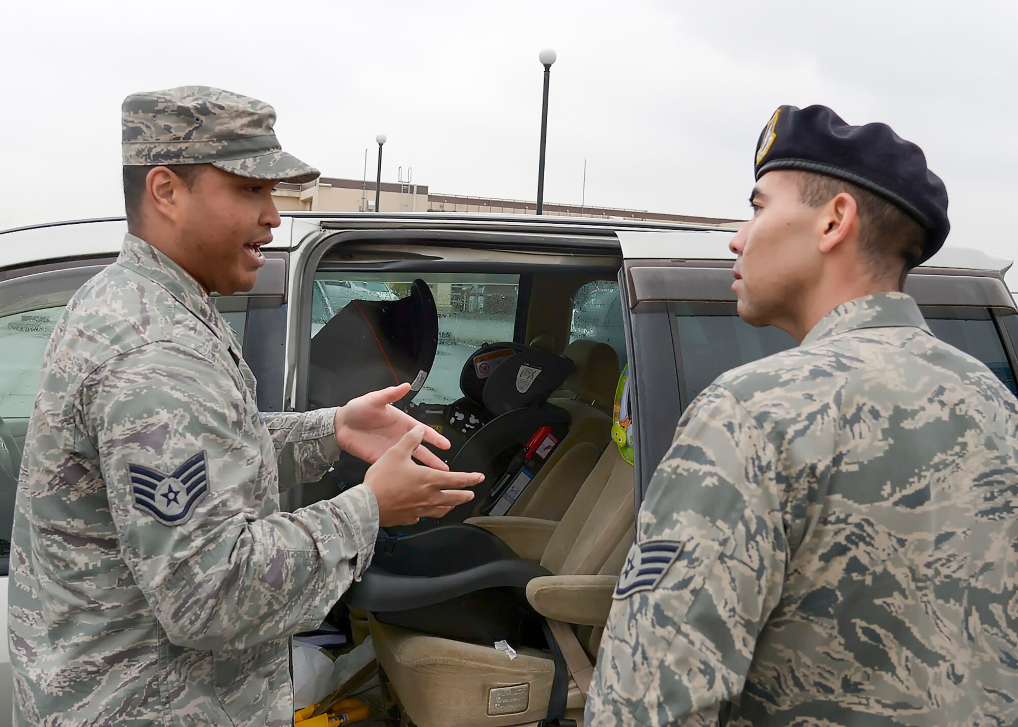 (Left to right) Staff Sgt. Trevor Alexis, 374th Civil Engineer Squadron lead fire crew chief, teaches how to install a child safety seat to Staff Sgt. Justin Tanimoto, 374th Security Forces Squadron trainer, during the safety week at Yokota Air Base, Japan, March 10, 2016.  The safety week was designed to improve personal and wingman’s safety. (U.S. Air Force photo by Machiko Imai/Released)