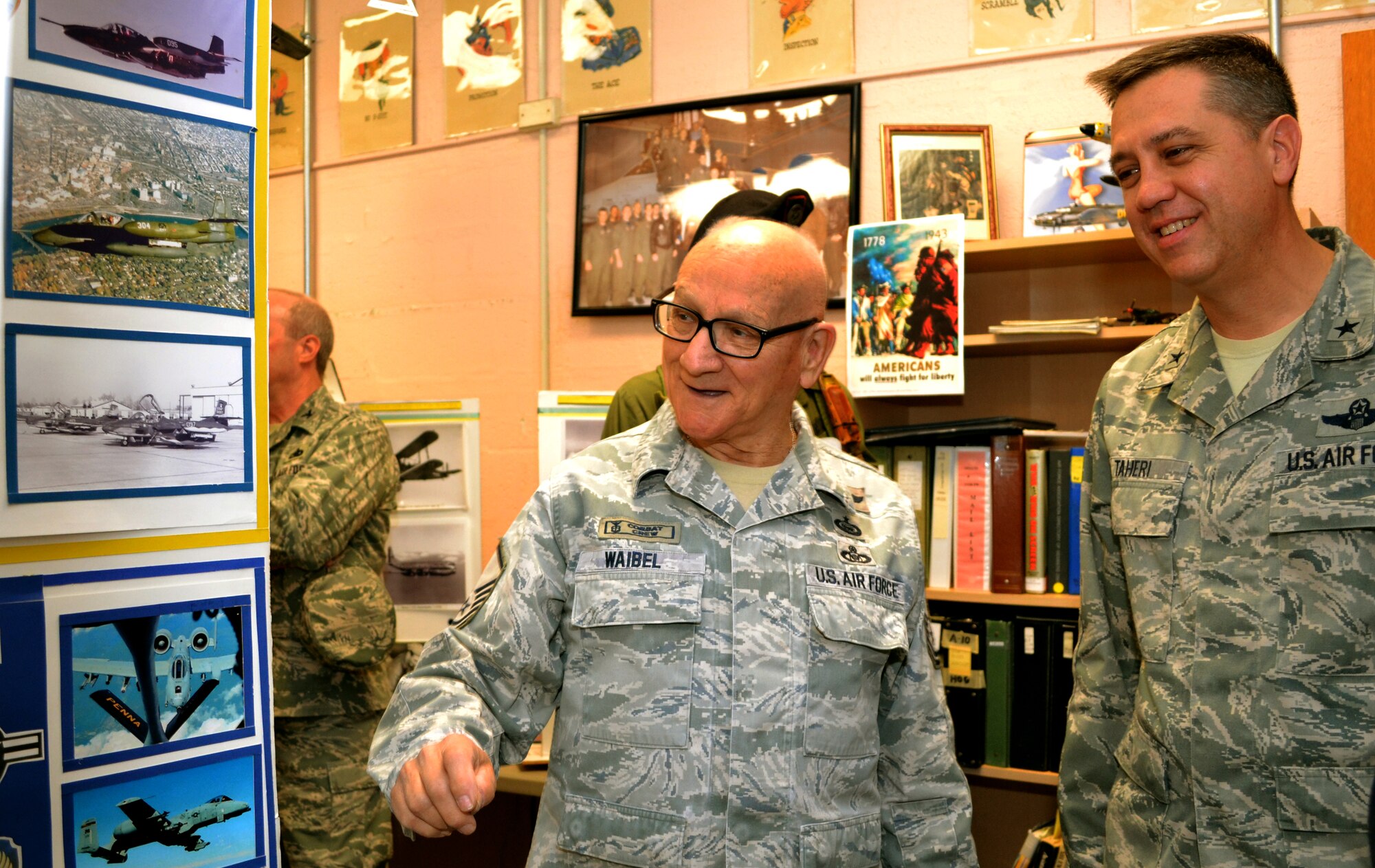 Retired Master Sgt. Jim Waibel, a historian who volunteers at the 111th Attack Wing, presents a display to Brig. Gen. Michael R. Taheri, the Commander of the Air National Guard Readiness Center, Joint Base Andrews, Maryland, in the Wing Historian Office at Horsham Air Guard Station, Pa., March 12, 2016. Taheri began his base tour viewing the Wing’s artifacts and exhibitions before proceeding to other units. (U.S. Air National Guard photo by Tech. Sgt. Andria Allmond)