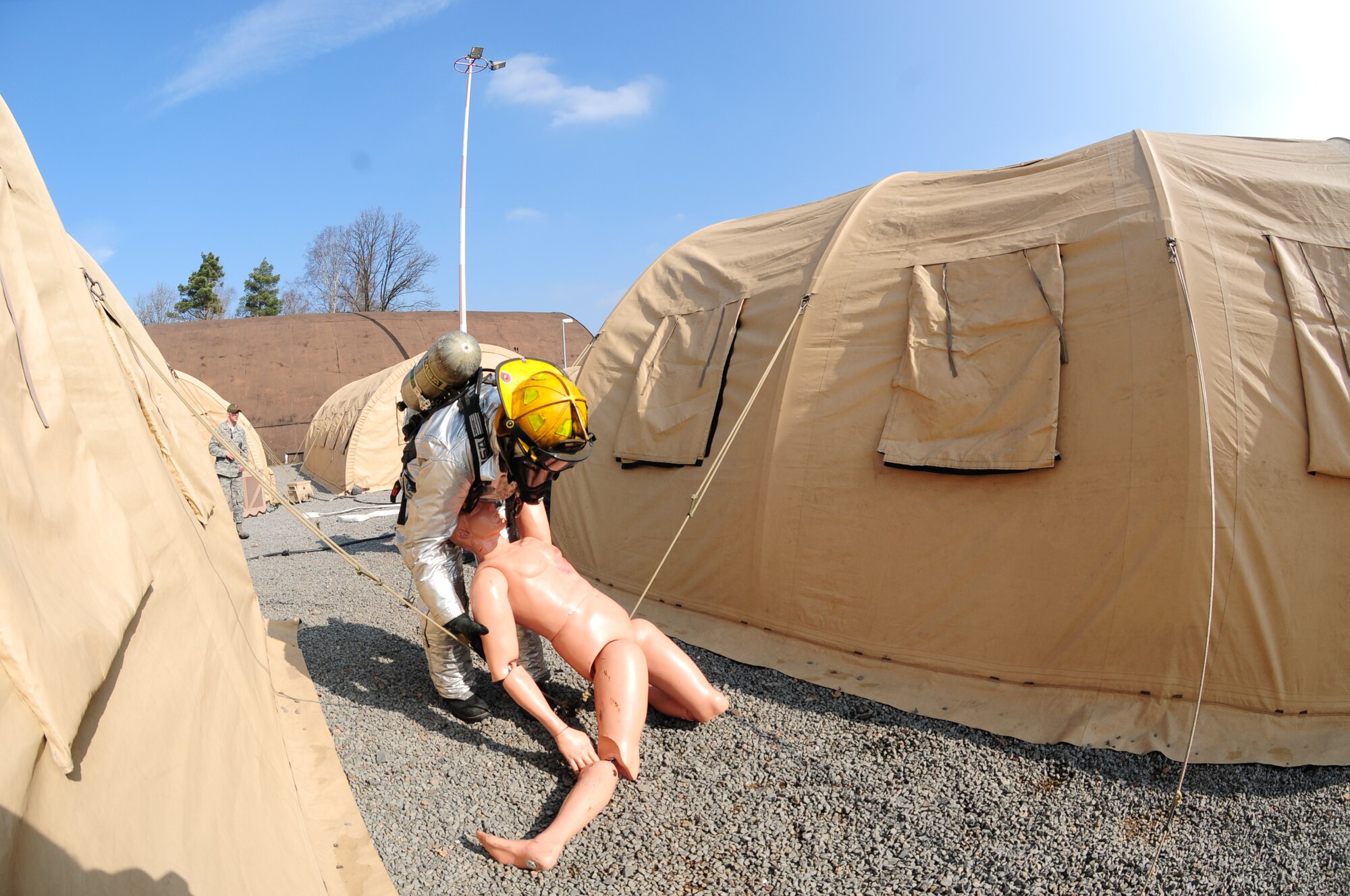 175th Fire and Emergency Services firefighters evacuate a simulated victim during exercise Silver Flag at Ramstein Air Base, Germany, March 12. (U.S. Air National Guard photo/ Senior Airman Erica Rodriguez)