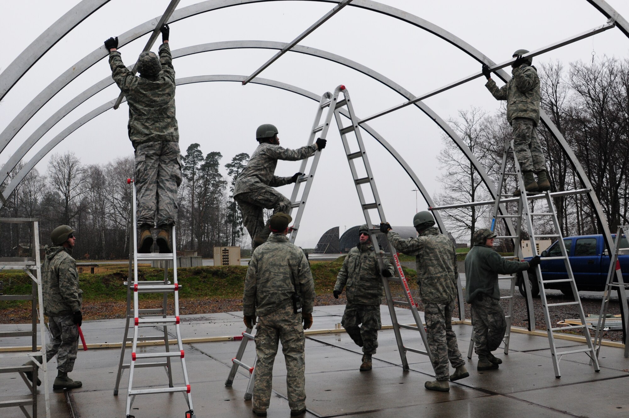 Civil engineer structures specialists build a large tent on the field training exercise area at Ramstein Air Base, Germany during Silver Flag training, March 7, 2016. Silver Flag participants utilized the tent as a dining facility during the bare base deployment training exercise. (U.S. Air National Guard photo/ Senior Airman Erica Rodriguez)