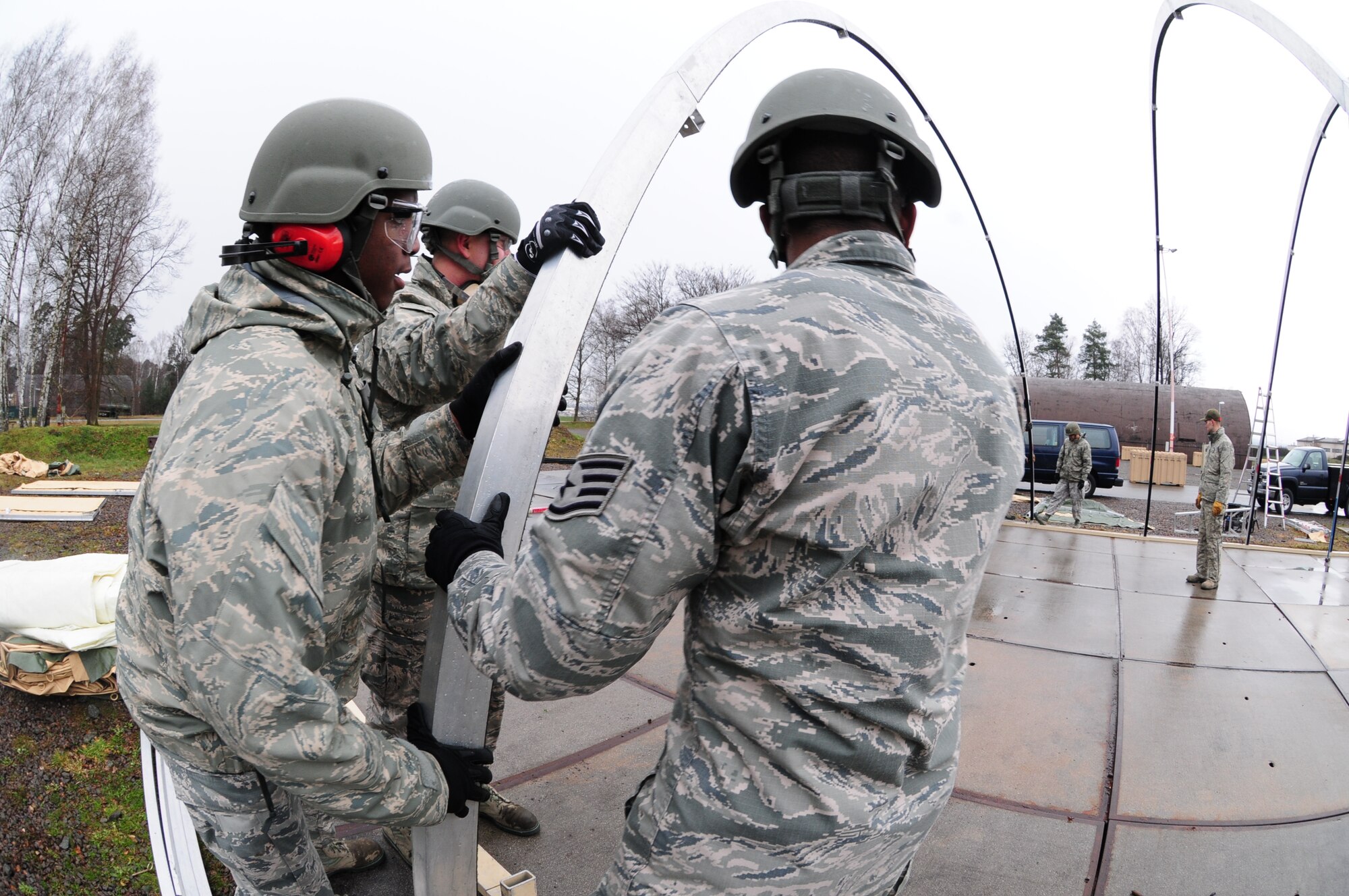 Civil engineer structures specialists build a large tent on the field training exercise area at Ramstein Air Base, Germany during Silver Flag training, March 7, 2016. Silver Flag participants utilized the tent as a dining facility during the bare base deployment training exercise. (U.S. Air National Guard photo/ Senior Airman Erica Rodriguez)