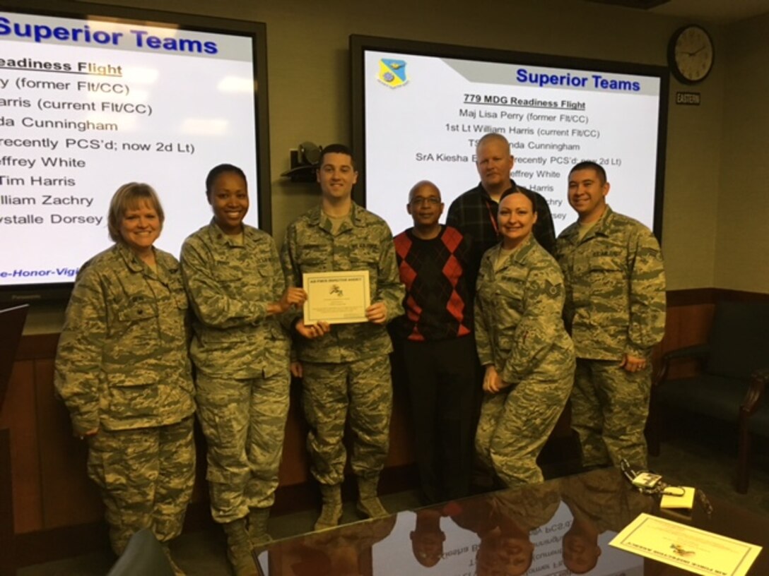 Colonel Wendy J. Beal, Inspector for the Air Force Inspection Agency presents a certificate for Superior Performance to the 779th Medical Group Readiness Flight lead by Maj. Lisa Perry and 1st Lt. William Harris.  (U.S. Air Force Photo by Tech. Sgt. Jillian Kozub/released)