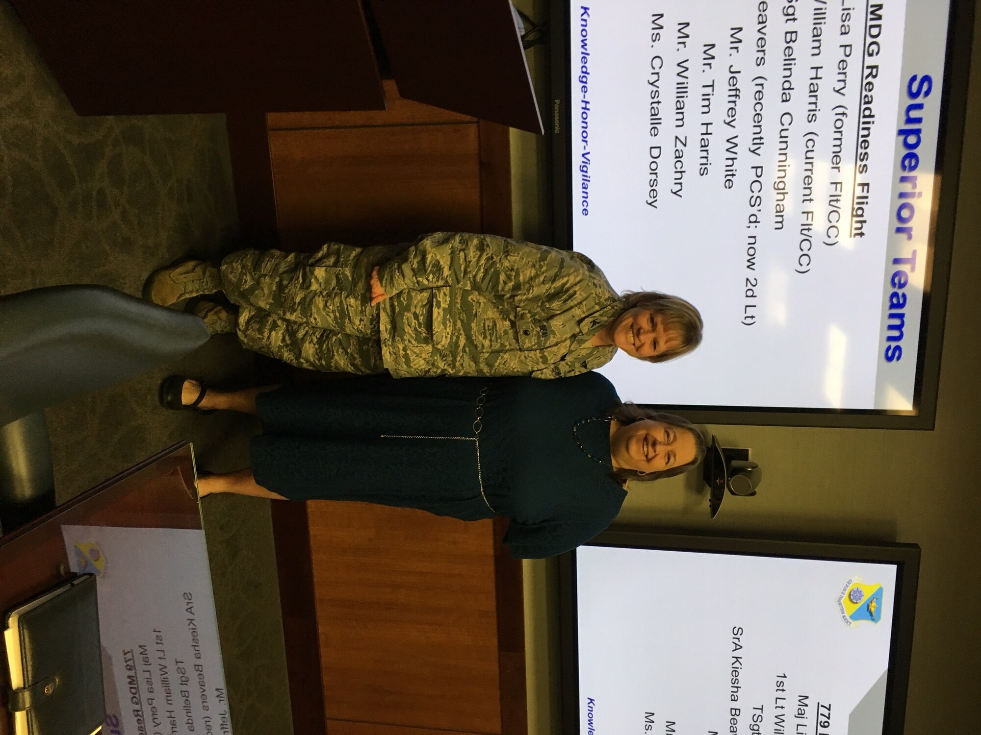 Colonel Wendy J. Beal, Inspector for the Air Force Inspection Agency presents a special inspection team coin to Mrs. Melanie Moore, 79th Medical Wing Public Affairs Officer. (U.S. Air Force Photo by Tech. Sgt. Jillian Kozub/released)
