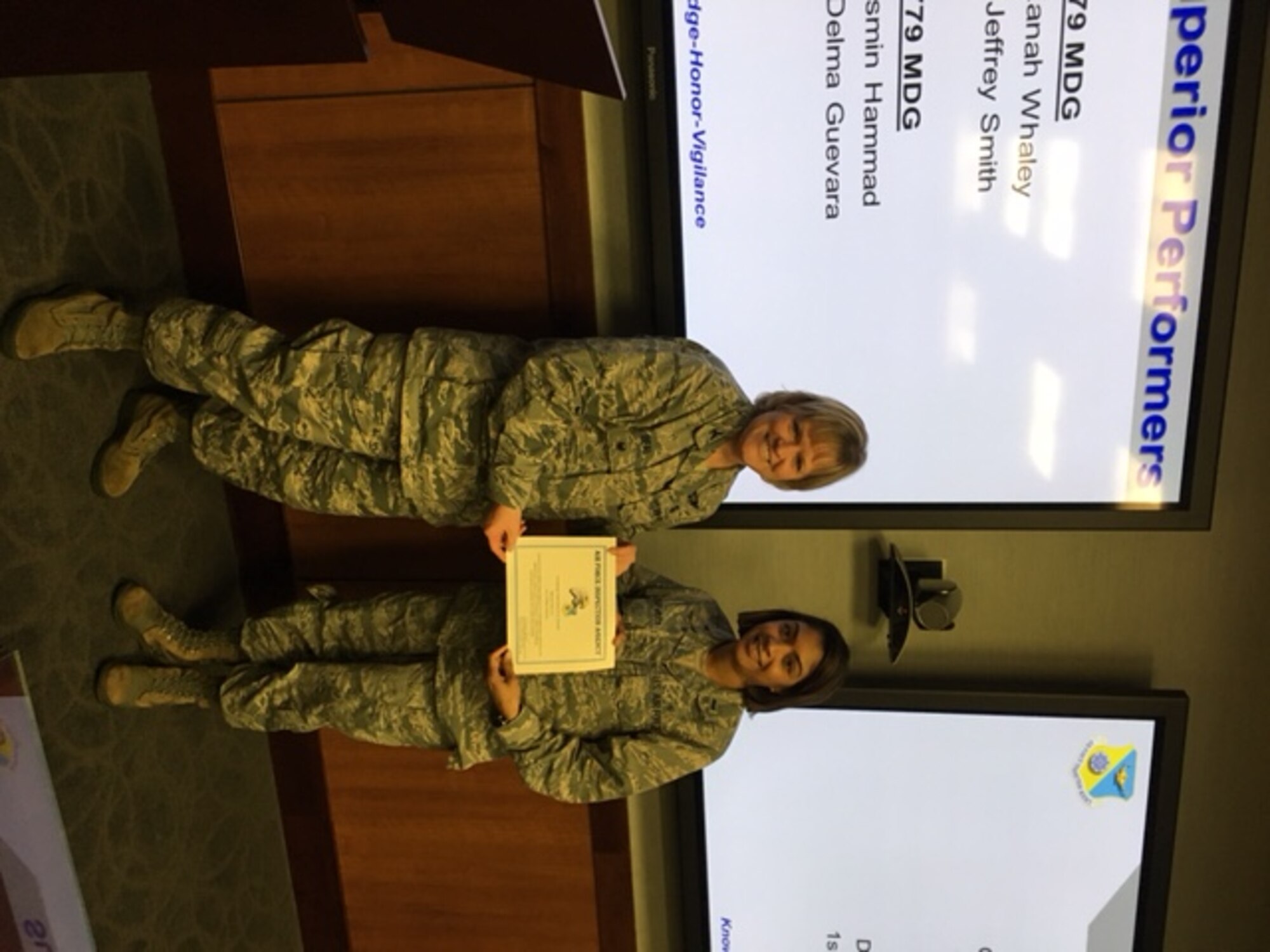 Colonel Wendy J. Beal, Inspector for the Air Force Inspection Agency presents a certificate for Superior Performance to 1st Lt. Delma Guevara, 779th Medical Group Resource Management Flight commander. (U.S. Air Force Photo by Tech. Sgt. Jillian Kozub/released)
