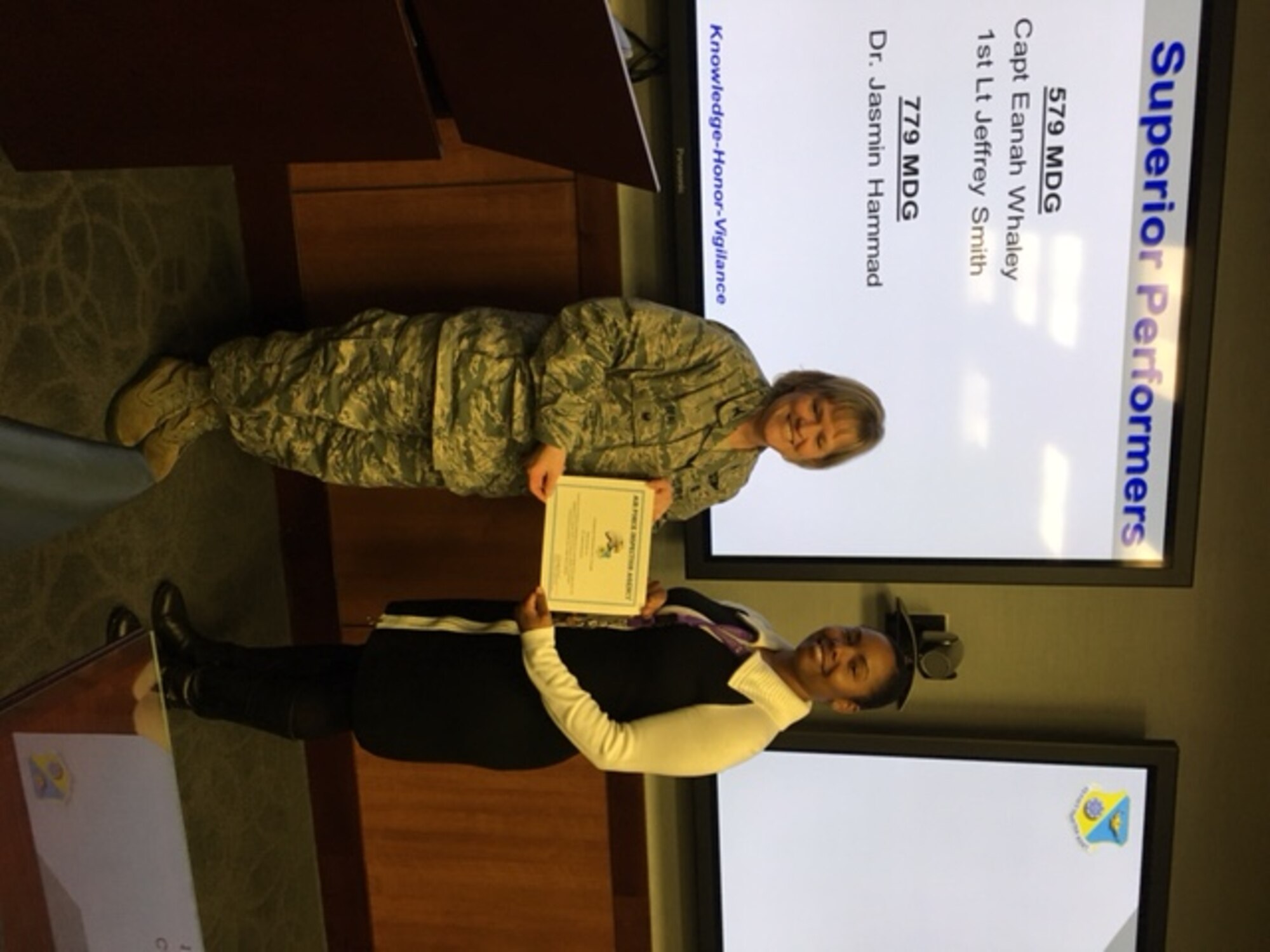 Colonel Wendy J. Beal, Inspector for the Air Force Inspection Agency presents a certificate for Superior Performance to Dr. Jasmin Hammad , 779th Medical Group. (U.S. Air Force Photo by Tech. Sgt. Jillian Kozub/released)
