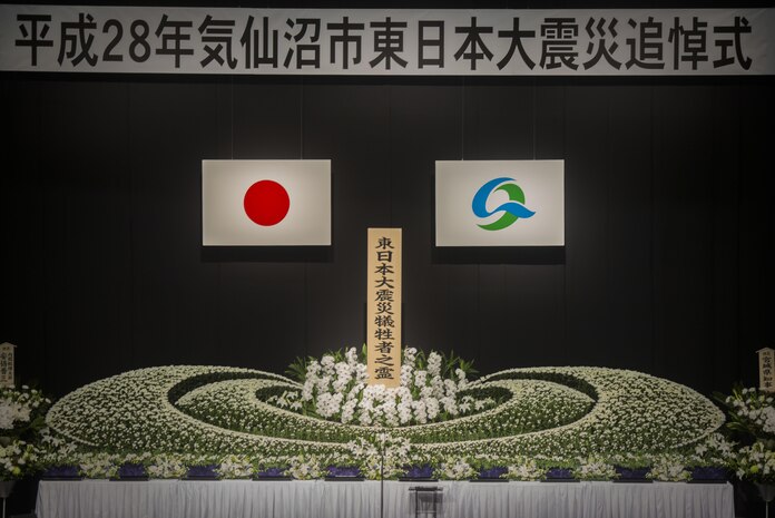 The Great East Japan earthquake, tsunami and nuclear disaster memorial sits on display before the start of the 5the Kesennuma City memorial ceremony March 11 in Kesennuma City. The memorial commemorates those lost and missing from the disaster which took place over five years ago. Col. Roger J. McFadden represented Marine Forces Japan who responded to the disaster as a part of Operation Tomodachi. Mcfadden along with city representatives and Kesennuma residents placed flowers on the memorial and observed a moment of silence at 2:46 p.m. Japan Standard Time. (U.S. Marine Corps photo by Sgt. Royce Dorman)