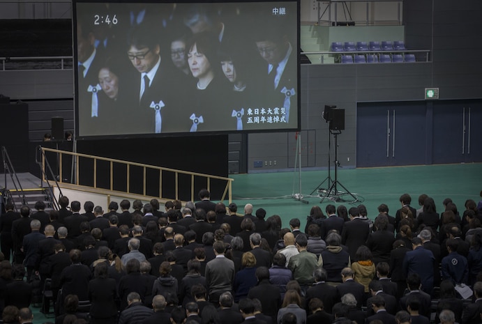 A moment of silence is observed at 2:46 p.m. Japan Standard time during the 5th Kesennuma City memorial ceremony remembering those who were lost in the Great East Japan earthquake, tsunami and nuclear disaster March 11 in Kesennuma City. Col. Roger J. McFadden represented Marine Forces Japan who responded to the disaster as a part of Operation Tomodachi. McFadden along with city representatives and Kesennuma City residents placed flowers on the memorial honoring the dead and missing. (U.S. Marine Corps photo by Sgt. Royce Dorman)