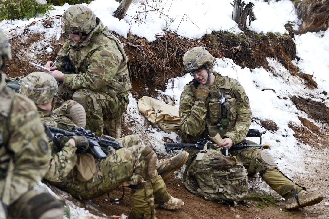 Army Staff Sgt. Richard Stotts, right, calls in the 9-line medevac for simulated casualties during a tactical casualty care exercise, part of a live-fire exercise at Tapa Training Area in Estonia, March 12, 2016. Stotts is a platoon sergeant assigned to the 3rd Squadron, 2nd Cavalry Regiment. 