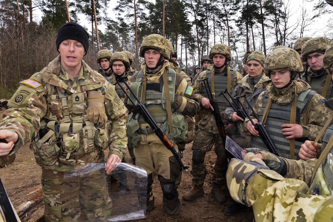 U.S. Army Sgt. 1st Class John Adkerson, left, teaches Ukrainian soldiers how to determine grid coordinates and points on a map during a map reading and land navigation class at the International Peacekeeping and Security Center near Yavoriv, Ukraine, March 5, 2016. Adkerson is a combat engineer assigned to the 3rd Infantry Division’s 3rd Battalion, 15th Infantry Regiment, 2nd Infantry Brigade Combat Team. Army photo by Staff Sgt. Adriana M. Diaz-Brown