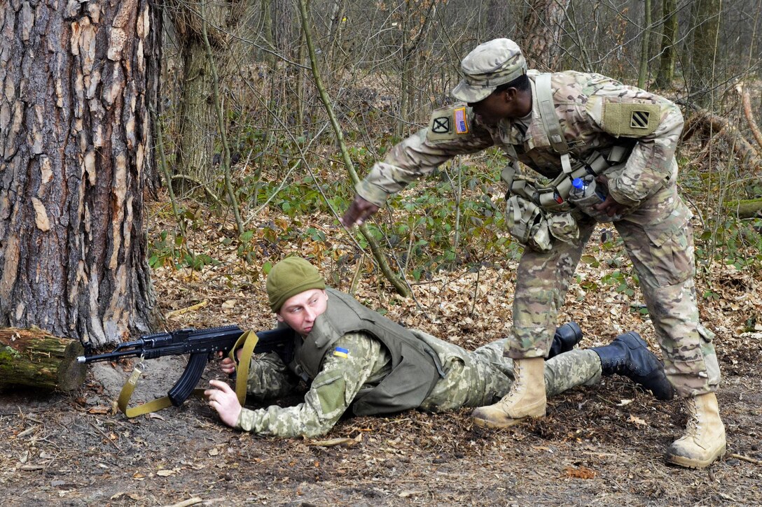 U.S. Army Sgt. Jackenson Jean, standing, instructs a Ukrainian soldier during a class on individual movement techniques at the International Peacekeeping and Security Center near Yavoriv, Ukraine, March 5, 2016. Jean is a combat engineer assigned to the 3rd Infantry Division’s 3rd Battalion, 15th Infantry Regiment, 2nd Infantry Brigade Combat Team. Army photo by Staff Sgt. Adriana M. Diaz-Brown