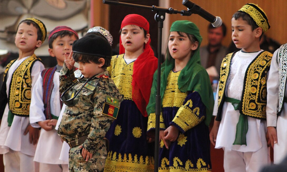 A boy dressed like his mother, who serves in the Afghan National Defense and Security Forces, salutes the women attending the Ministry of the Interior International Women’s Day celebration in Kabul, Afghanistan, March 13, 2016. The event honored women’s contributions to Afghanistan’s security, and highlighted the way forward for women’s rights. Navy photo by Lt. Charity Edgar