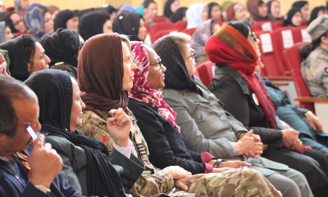 Australian Air Force Group Capt. Deanne Gibbon, third from left, senior advisor on gender and Velika Carew Moore, fourth from left, senior gender advisor for the Ministry of the Interior, listen-in during the Ministry of the Interior International Women’s Day celebration in Kabul, Afghanistan, March 13, 2016. The Resolute Support Mission Gender Advisor directorate trains, advises and assists Afghan Security Institutions to integrate United Nations Security Council Resolution 1325 and gender perspective in order to operate with full respect for human rights and gender equality and to promote women's active and meaningful participation within Afghan Security Institutions and the Afghan National Defense and Security Forces. Navy photo by Lt. Charity Edgar